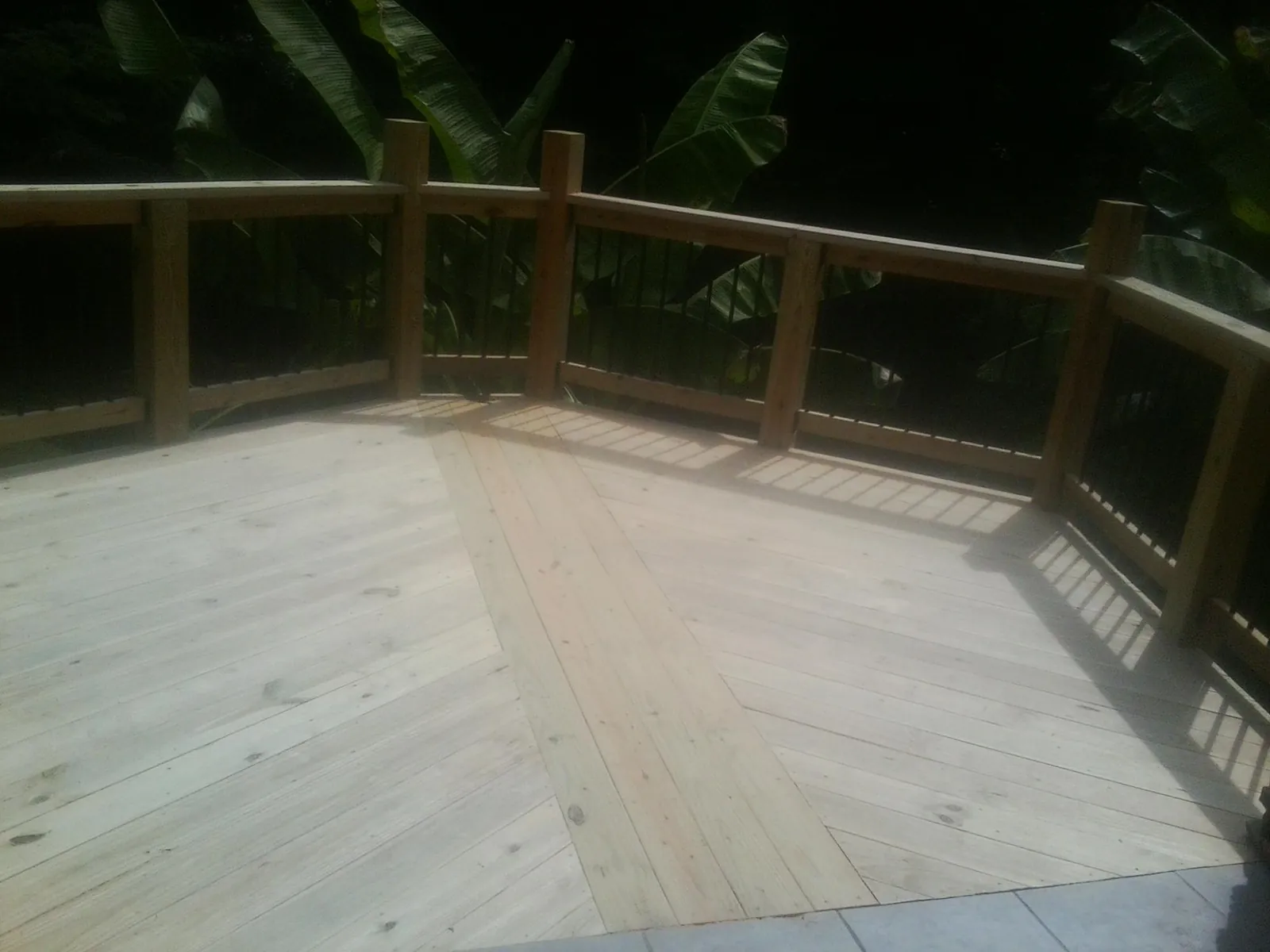 New wood deck and railing built off the back of a home in Big Rock